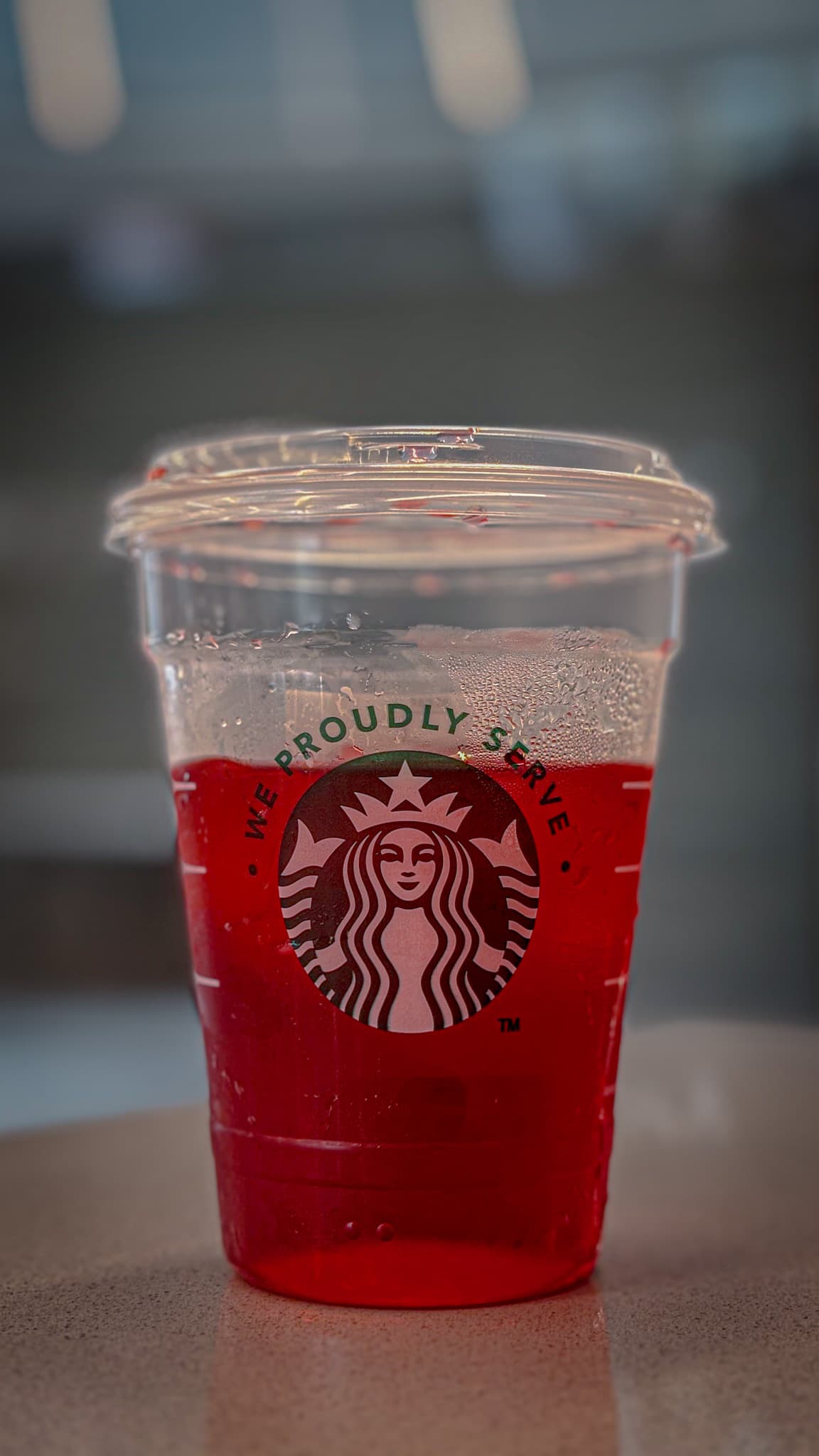 Red Starbucks drink cup photographed close up inside Common Grounds