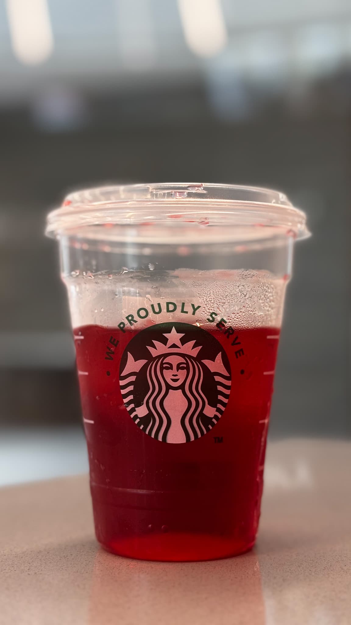 Unedited Red Starbucks drink cup photographed close up inside Common Grounds